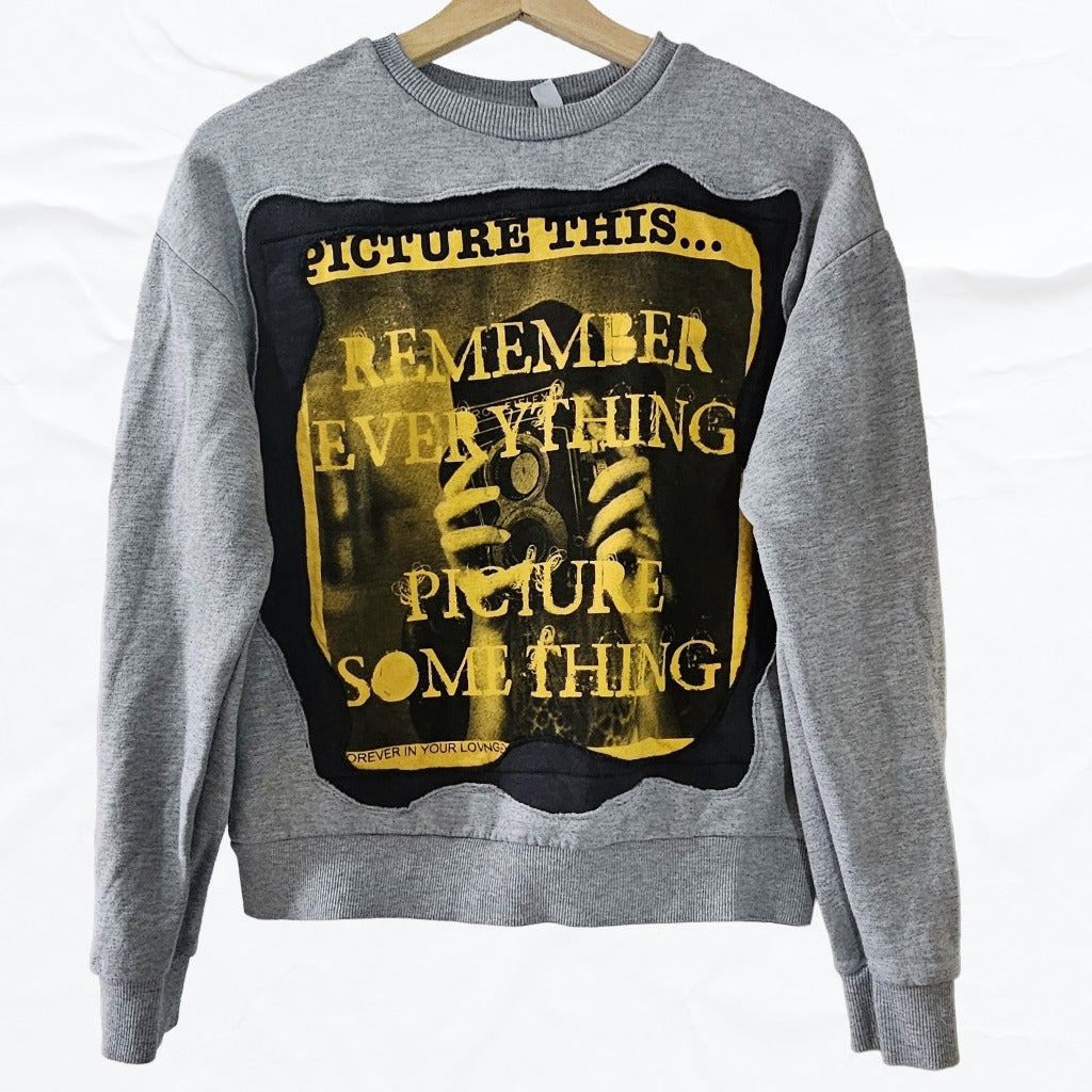 Upcycled Gray sweatshirt with a graphic design featuring text and a black and yellow color scheme.