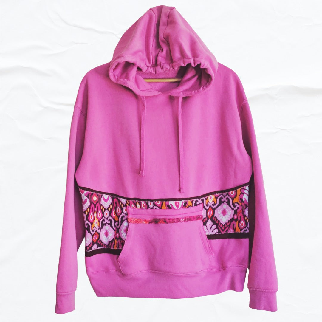 Pink hoodie with colorful patterned trim on a white background