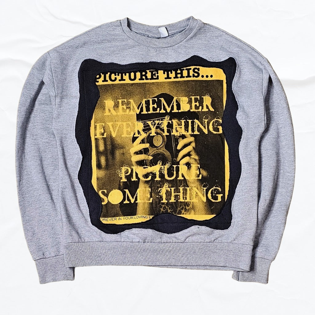 Upcycled Gray sweatshirt with a graphic design featuring text and a black and yellow color scheme.